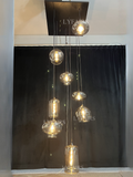 https://cdn.shopify.com/s/files/1/0554/8562/8591/files/LYFAIRSModernSmokeGrayGlassPendantLightFixtureChandelier.png?v=1766650593