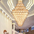 https://cdn.shopify.com/s/files/1/0736/8795/7790/files/extra-large-luxury-multi-tier-gold-crystalchandelier-for-stairslarge-high-ceiling-room-merlin-lamps-7.jpg?v=1765406242